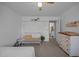 Bedroom with white walls, crib, shelf decor, and an ensuite bathroom entrance at 1208 Briarcliff Rd, Burlington, NC 27215