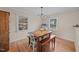 Bright dining room features hardwood floors and matching wooden table and benches at 1208 Briarcliff Rd, Burlington, NC 27215