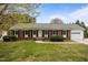 Charming single-story brick home featuring a well-maintained lawn and attached garage at 1208 Briarcliff Rd, Burlington, NC 27215