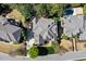 Aerial view of the property, featuring a pool, lush landscaping, and a spacious driveway at 121 Highclere Ln, Cary, NC 27518