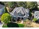 Stunning aerial view of home featuring lush landscaping, impeccable lawn and detailed roof at 121 Highclere Ln, Cary, NC 27518