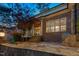 A rear exterior of the property featuring a stone patio and manicured lawn at 121 Highclere Ln, Cary, NC 27518