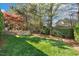 Landscaped backyard features a stone patio with seating, perfect for entertaining at 121 Highclere Ln, Cary, NC 27518