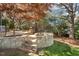 Stone patio features curved seating, perfect for outdoor entertaining at 121 Highclere Ln, Cary, NC 27518