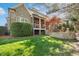 Backyard featuring a stone patio, covered porch, and lush green lawn at 121 Highclere Ln, Cary, NC 27518