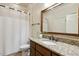 Cozy bathroom with granite countertops, wood vanity, and a shower with a curtain at 121 Highclere Ln, Cary, NC 27518