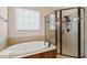 Luxurious bathroom featuring a tub, a glass enclosed shower and tile flooring at 121 Highclere Ln, Cary, NC 27518