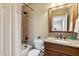 Bathroom featuring a shower with tile surround, granite vanity, and neutral color palette at 121 Highclere Ln, Cary, NC 27518