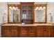 Bathroom featuring double sinks, granite countertops, custom cabinetry, and large mirrors at 121 Highclere Ln, Cary, NC 27518