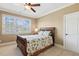 Comfortable bedroom with a ceiling fan, a window, and a wooden-framed bed with patterned linens at 121 Highclere Ln, Cary, NC 27518
