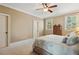 Bedroom with windows, ceiling fan, carpeted floors and light colored walls at 121 Highclere Ln, Cary, NC 27518