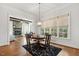 Bright breakfast nook features hardwood floors, large windows with natural light and designer chandelier at 121 Highclere Ln, Cary, NC 27518