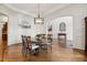 Open-concept dining room featuring hardwood floors and an elegant chandelier at 121 Highclere Ln, Cary, NC 27518
