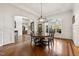 Bright dining room with an elegant chandelier and beautiful hardwood flooring at 121 Highclere Ln, Cary, NC 27518