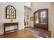 Grand foyer features hardwood floors, arched double doors, a decorative mirror, and neutral decor at 121 Highclere Ln, Cary, NC 27518