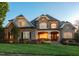 A beautifully designed home with a manicured lawn, stone facade, and a welcoming front porch at 121 Highclere Ln, Cary, NC 27518
