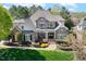 Beautiful two-story brick and stone home with manicured lawn and landscaped front garden at 121 Highclere Ln, Cary, NC 27518