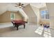 Spacious game room with a pool table, sloped ceilings, and natural light from multiple windows at 121 Highclere Ln, Cary, NC 27518