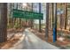 Beautiful greenway trail entrance with mature trees and welcome sign at 121 Highclere Ln, Cary, NC 27518