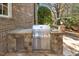 Outdoor kitchen area with a stainless steel gas grill, stone countertops and built-in storage at 121 Highclere Ln, Cary, NC 27518