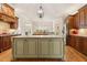 Spacious kitchen featuring a large kitchen island, custom cabinetry, and granite countertops at 121 Highclere Ln, Cary, NC 27518