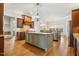 Open kitchen featuring a large island, custom cabinetry, granite countertops, and stainless steel appliances at 121 Highclere Ln, Cary, NC 27518