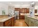 Kitchen featuring wooden cabinets, stainless steel appliances, granite countertops, and hardwood flooring at 121 Highclere Ln, Cary, NC 27518