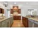 Kitchen featuring hardwood floors, granite countertops, wooden cabinets, and stainless steel appliances at 121 Highclere Ln, Cary, NC 27518