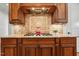 Close-up of the cooktop with granite countertops and custom wooden cabinets in the kitchen at 121 Highclere Ln, Cary, NC 27518