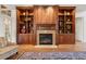 Bright living room features fireplace with custom built-ins, hardwood floors, and elegant decor at 121 Highclere Ln, Cary, NC 27518
