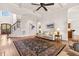 Open living room with hardwood floors, coffered ceilings, neutral paint, and staircase access at 121 Highclere Ln, Cary, NC 27518