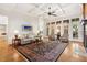 Elegant living room with coffered ceilings, hardwood floors, fireplace, and large windows with views at 121 Highclere Ln, Cary, NC 27518