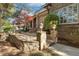 Charming stone patio featuring decorative stone pillars, lanterns, and lush landscaping at 121 Highclere Ln, Cary, NC 27518