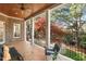 Inviting covered porch with classic columns, a ceiling fan, and comfortable seating overlooking the lawn at 121 Highclere Ln, Cary, NC 27518