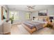 Well lit bedroom with neutral tones, hard wood furniture, fluffy rug and a ceiling fan at 124 Ripley Ct, Cary, NC 27513