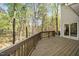 Wooden deck with wooded scenery and sliding glass door access to the home at 124 Ripley Ct, Cary, NC 27513