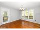 Bright dining room featuring hardwood floors, a door to the outside, and a window with a view at 124 Ripley Ct, Cary, NC 27513