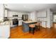 Kitchen boasts hardwood floors, granite countertops, stainless steel appliances, and a kitchen island with seating at 124 Ripley Ct, Cary, NC 27513
