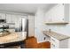 Bright kitchen featuring a stainless steel refrigerator, granite countertops, and a built in desk space at 124 Ripley Ct, Cary, NC 27513