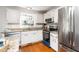 Kitchen featuring stainless steel appliances, granite countertops, and hardwood floors at 124 Ripley Ct, Cary, NC 27513