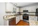 Kitchen featuring granite countertops, stainless steel appliances and sink, and white cabinets at 124 Ripley Ct, Cary, NC 27513