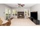Bright living room features a stone fireplace, hardwood floors and direct access to outdoor deck at 124 Ripley Ct, Cary, NC 27513