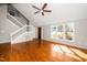 Bright living room with hardwood floors, large windows, and a staircase leading to the upper level at 124 Ripley Ct, Cary, NC 27513