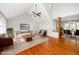 Open-concept living room featuring hardwood floors, a ceiling fan, and lots of natural light at 124 Ripley Ct, Cary, NC 27513