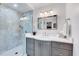 Bathroom with modern fixtures, gray vanity, and marble-look tiled shower at 1308 Helmsdale Dr, Cary, NC 27511