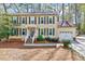 Traditional two-story home with neutral siding, dark shutters, and an attached garage at 1308 Helmsdale Dr, Cary, NC 27511