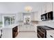 Bright kitchen with white cabinets, granite countertops, stainless steel appliances, and modern fixtures at 1308 Helmsdale Dr, Cary, NC 27511