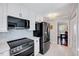 Modern kitchen features stainless steel appliances, white cabinets, and a tile backsplash at 1308 Helmsdale Dr, Cary, NC 27511