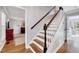 Elegant staircase with wood treads, white risers, and a dark wood handrail at 1308 Helmsdale Dr, Cary, NC 27511