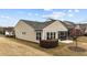 Backyard of home featuring neutral siding, screened in porch and budding trees at 1404 Palmer Hill Dr, Durham, NC 27703